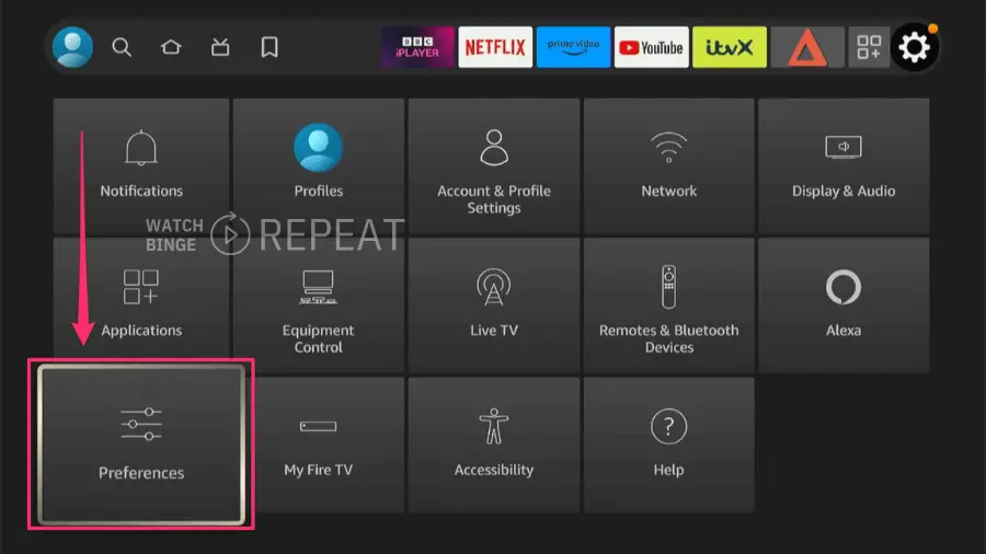  Firestick home screen menu highlighting the 'Preferences' option with a red arrow pointing downwards.