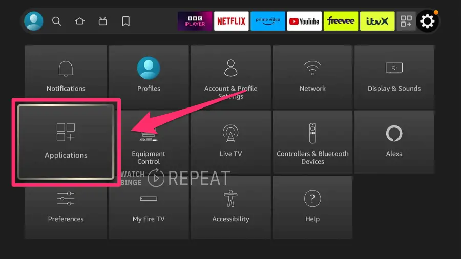 A grid of Firestick menu options on a smart TV interface. The "Applications" icon, which is highlighted with a red box, is indicated with an arrow. 