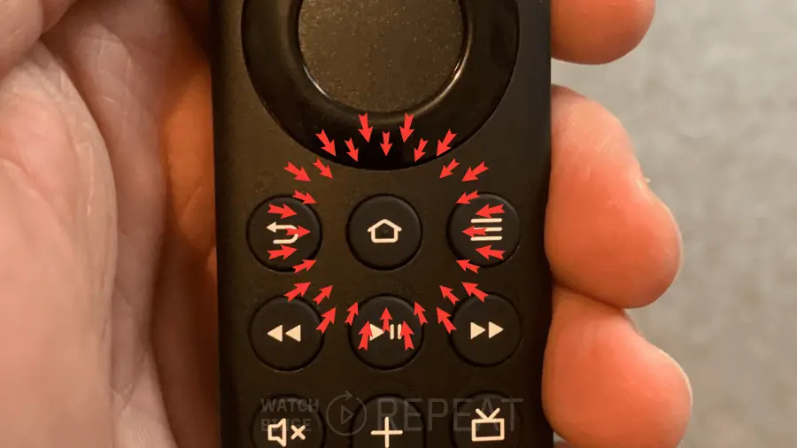 Fire TV remote in a hand with red arrows pointing to the Home button, indicating the way to repair the remote.