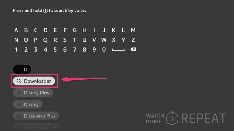 A firestick interface on a TV screen with the 'Downloader' app as a search result, selected with a red box and arrow indicating its position among other search suggestions.