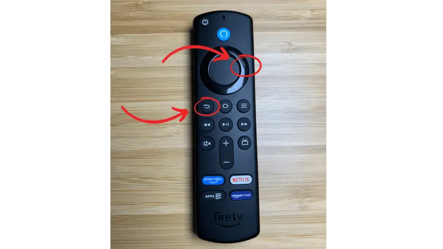 An Amazon Fire TV remote control with red arrows pointing to two buttons. The arrows indicate to press the right button on the circular navigation pad and the back button (shaped like an arrow curving left) at the same time.