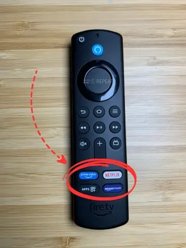 Firestick remote with Apps button highlighted and pointed on with red arrow