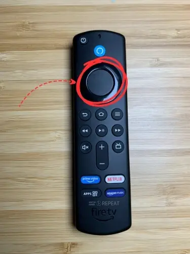 Firestick remote with Circle button highlighted and pointed on with red arrow