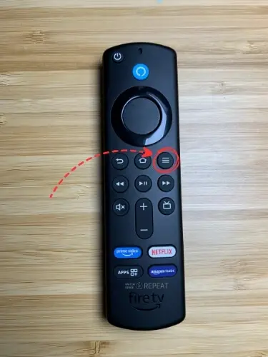 Firestick remote with Menu button highlighted and pointed on with red arrow
