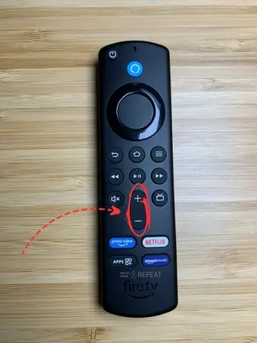 Firestick remote with Volume button highlighted and pointed on with red arrow