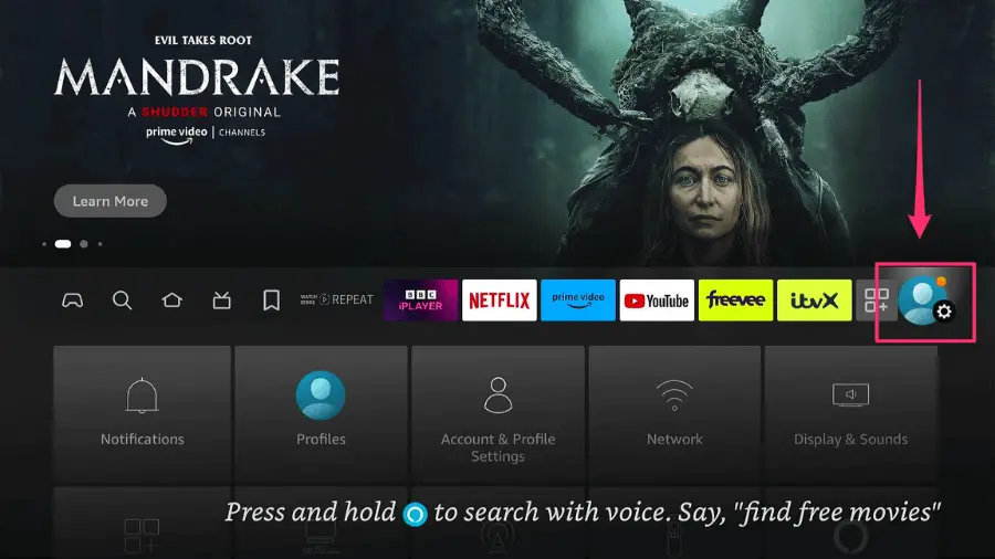 Home screen of Amazon Fire Stick with a highlighted profile icon in the top right corner, indicating where to navigate to access profiles.